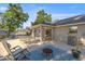 Relaxing outdoor patio with comfortable seating, an outdoor fireplace, and covered area at 8215 Sw 53Rd Ct, Ocala, FL 34476