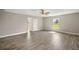 Neutral bedroom with wood-look flooring and a window offering natural light and views of the outdoors at 8725 Sw 136Th Ter, Dunnellon, FL 34432