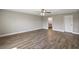 Expansive bedroom with wood-look flooring, ceiling fan, and an ensuite bathroom for added convenience and privacy at 8725 Sw 136Th Ter, Dunnellon, FL 34432