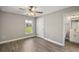 This bedroom offers ample natural light with hardwood floors and neutral walls at 8725 Sw 136Th Ter, Dunnellon, FL 34432