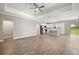 Open-concept living room featuring hardwood floors and a modern kitchen with stainless steel appliances at 8725 Sw 136Th Ter, Dunnellon, FL 34432
