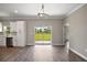Spacious living room featuring sliding glass doors leading to the backyard and connecting to the kitchen area at 8725 Sw 136Th Ter, Dunnellon, FL 34432