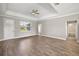 Bright, spacious living room with hardwood floors and a view into the hallway and bathroom at 8725 Sw 136Th Ter, Dunnellon, FL 34432