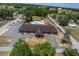 An aerial view shows a community center's outdoor pool, building design, and surrounding landscape at 10040 Sw 93Rd Ct, Ocala, FL 34481