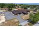 Aerial view shows the building's design, ample parking, and outdoor pool of a community center at 10040 Sw 93Rd Ct, Ocala, FL 34481