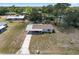 Aerial view showcasing the home with a covered parking area, a neatly kept yard, and mature trees at 10040 Sw 93Rd Ct, Ocala, FL 34481