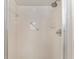 Updated bathroom with white tile and hand rails in shower at 10040 Sw 93Rd Ct, Ocala, FL 34481