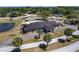Aerial view showcasing the clubhouse with pool, landscaping, and parking area, offering a resort-style community amenity at 10040 Sw 93Rd Ct, Ocala, FL 34481