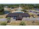 Aerial view of the community clubhouse with a charming entrance, ample parking, and well-maintained landscaping at 10040 Sw 93Rd Ct, Ocala, FL 34481
