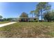 Charming single-story home featuring a covered carport and a well-maintained front yard at 10040 Sw 93Rd Ct, Ocala, FL 34481
