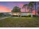 Charming single-story home featuring a covered carport and a well-maintained front yard at 10040 Sw 93Rd Ct, Ocala, FL 34481