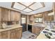 Cozy kitchen features wood cabinets, light countertops, and a window above the sink at 10040 Sw 93Rd Ct, Ocala, FL 34481