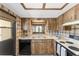 Well-lit kitchen with light countertops, wood cabinetry, and a window above the sink at 10040 Sw 93Rd Ct, Ocala, FL 34481