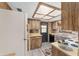 Kitchen with wood cabinets, a white refrigerator, and a window above the sink at 10040 Sw 93Rd Ct, Ocala, FL 34481