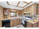 Charming kitchen featuring wood cabinets, light countertops, and modern appliances at 10040 Sw 93Rd Ct, Ocala, FL 34481