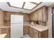 Vintage kitchen with wooden cabinets, neutral countertops and lighting at 10040 Sw 93Rd Ct, Ocala, FL 34481