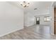 Open-concept living area boasts wood-look floors and ample natural light from door and window at 10040 Sw 93Rd Ct, Ocala, FL 34481