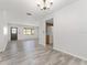 Spacious open-concept layout with wood-look floors, connecting the living and dining areas at 10040 Sw 93Rd Ct, Ocala, FL 34481