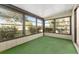 Enclosed patio featuring large windows and green carpet, creating a tranquil retreat at 10040 Sw 93Rd Ct, Ocala, FL 34481