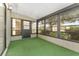 Enclosed patio with large windows provides peaceful views of the surrounding greenery at 10040 Sw 93Rd Ct, Ocala, FL 34481