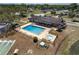Aerial view of a sparkling community pool with an adjacent hot tub, surrounded by lounge chairs and well-kept grounds at 10040 Sw 93Rd Ct, Ocala, FL 34481