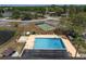 Aerial view of a sparkling pool and spa area, complemented by shuffleboard courts for community leisure activities at 10040 Sw 93Rd Ct, Ocala, FL 34481
