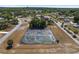 Aerial view of tennis courts with green playing surfaces and a surrounding fence, providing an active recreational space at 10040 Sw 93Rd Ct, Ocala, FL 34481