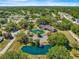 An aerial view of the community clubhouse, pool, and green spaces nestled in a serene neighborhood at 10946 Sw 65Th Ave, Ocala, FL 34476