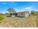 View of a backyard with a screened-in lanai and chain link fence on a sunny day at 10946 Sw 65Th Ave, Ocala, FL 34476