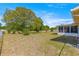 Expansive backyard featuring mature trees, a screened-in lanai, and a fully fenced yard at 10946 Sw 65Th Ave, Ocala, FL 34476