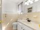 Well-lit bathroom featuring single sink vanity and tub-shower combo, creating a functional space at 10946 Sw 65Th Ave, Ocala, FL 34476