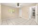 Tile flooring, neutral walls, and natural light provide a calming feeling in this bedroom at 10946 Sw 65Th Ave, Ocala, FL 34476