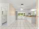 Bright dining room features tile flooring, sliding glass doors to sunroom, and updated kitchen at 10946 Sw 65Th Ave, Ocala, FL 34476
