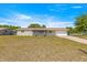 Charming home with a well-maintained lawn, attached garage, and inviting front porch at 10946 Sw 65Th Ave, Ocala, FL 34476