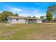 Inviting single-story home with a screened-in porch, attached garage, and lush green lawn at 10946 Sw 65Th Ave, Ocala, FL 34476