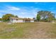 Front exterior of a charming single-story home with a well-manicured lawn and long driveway at 10946 Sw 65Th Ave, Ocala, FL 34476