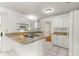 Modern kitchen with granite countertops, white cabinets, and stainless steel appliances at 10946 Sw 65Th Ave, Ocala, FL 34476