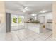 Bright kitchen area features white cabinetry, granite countertops, stainless steel appliances, and tile flooring at 10946 Sw 65Th Ave, Ocala, FL 34476