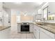 Eat-in kitchen showcasing granite countertops, stainless appliances, tile floors, and white cabinetry at 10946 Sw 65Th Ave, Ocala, FL 34476