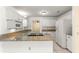 Updated kitchen showcasing granite countertops, white cabinets, and stainless steel appliances at 10946 Sw 65Th Ave, Ocala, FL 34476