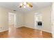 Cozy living room featuring wood-look floors, neutral walls, and an open view to the adjacent kitchen at 10946 Sw 65Th Ave, Ocala, FL 34476