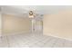 Open living space with tile floors, neutral walls, and a view of the connecting hallway and bathroom at 10946 Sw 65Th Ave, Ocala, FL 34476