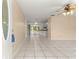 Open-concept living space with tile flooring and seamless flow into kitchen and screened patio at 10946 Sw 65Th Ave, Ocala, FL 34476