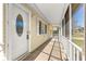 Entrance to the house, including a screened porch and the front door, which features an oval glass design at 10946 Sw 65Th Ave, Ocala, FL 34476