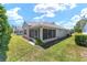 Lawn with landscaping and an enclosed patio area attached to the home's exterior at 11133 Sw 73Rd Ter, Ocala, FL 34476