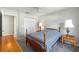 Bright bedroom with a ceiling fan and a cozy bed with blue and white striped sheets at 11133 Sw 73Rd Ter, Ocala, FL 34476