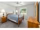 Comfortable bedroom with carpet, ceiling fan, and natural light from the window at 11133 Sw 73Rd Ter, Ocala, FL 34476