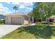 Inviting front yard with lush lawn and well-maintained landscaping showcasing the charming exterior of this single-story home at 11133 Sw 73Rd Ter, Ocala, FL 34476