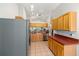 Bright and open kitchen featuring tile floors, stainless steel appliances, and warm wooden cabinetry at 11133 Sw 73Rd Ter, Ocala, FL 34476