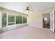 Well-lit patio with screen enclosure featuring tile flooring and a ceiling fan at 11133 Sw 73Rd Ter, Ocala, FL 34476